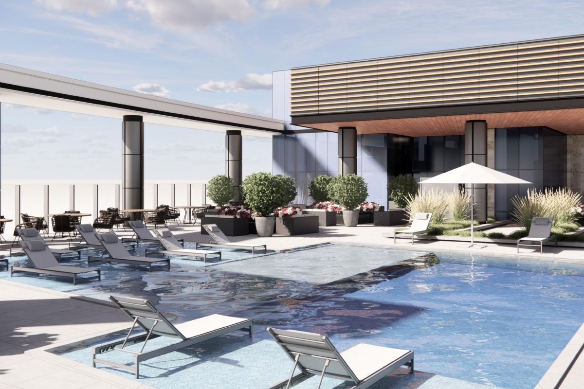 Modern rooftop pool area with lounge chairs, potted plants, a shaded section, and a partly cloudy sky above.