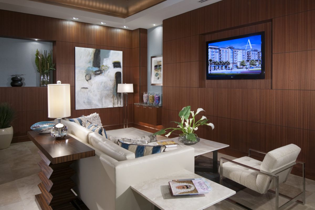 Modern living room with wood-paneled walls, white sofa, art, TV, and Ashton Candlestick Cove-inspired contemporary décor.