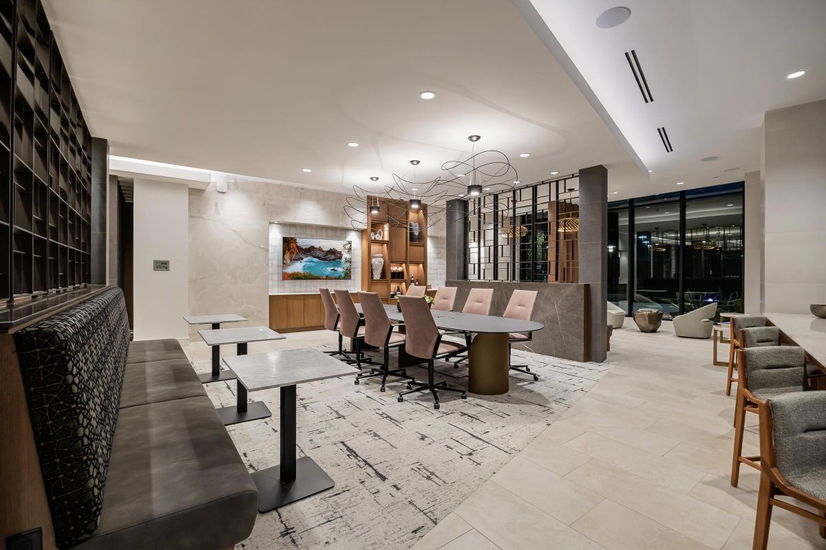 Hanover Laguna Niguel Modern conference room with a long table, chairs, wall art, and decorative ceiling lights.