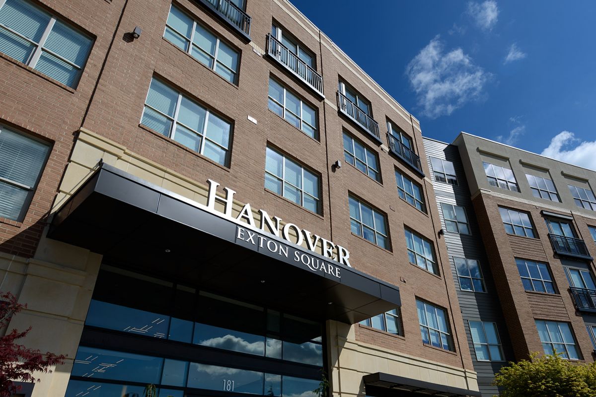 Exterior view of Hanover Exton Square luxury apartments under a blue sky with a few clouds.