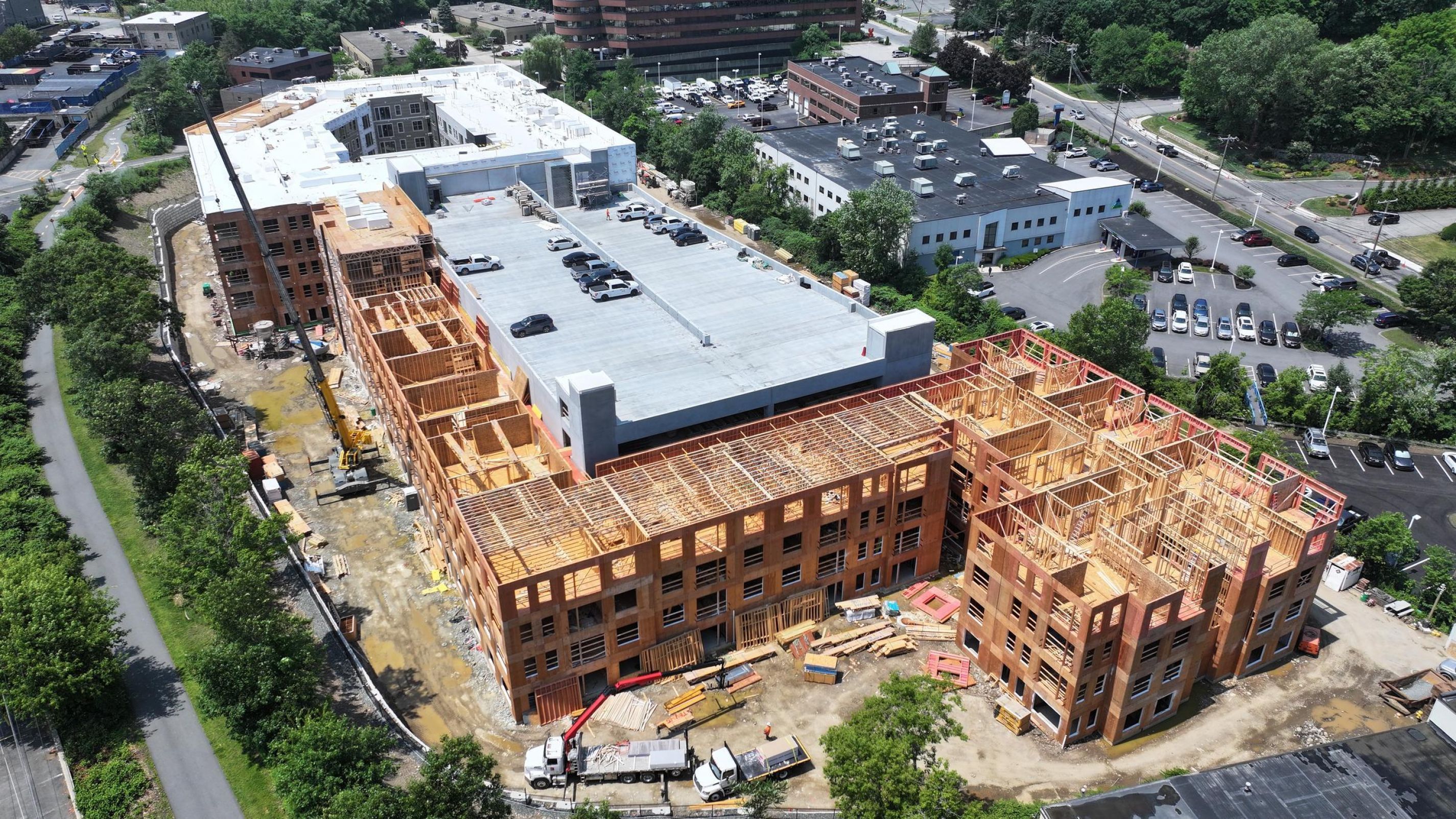 Hanover Company Aerial view of a large building under construction, surrounded by roads and trees.