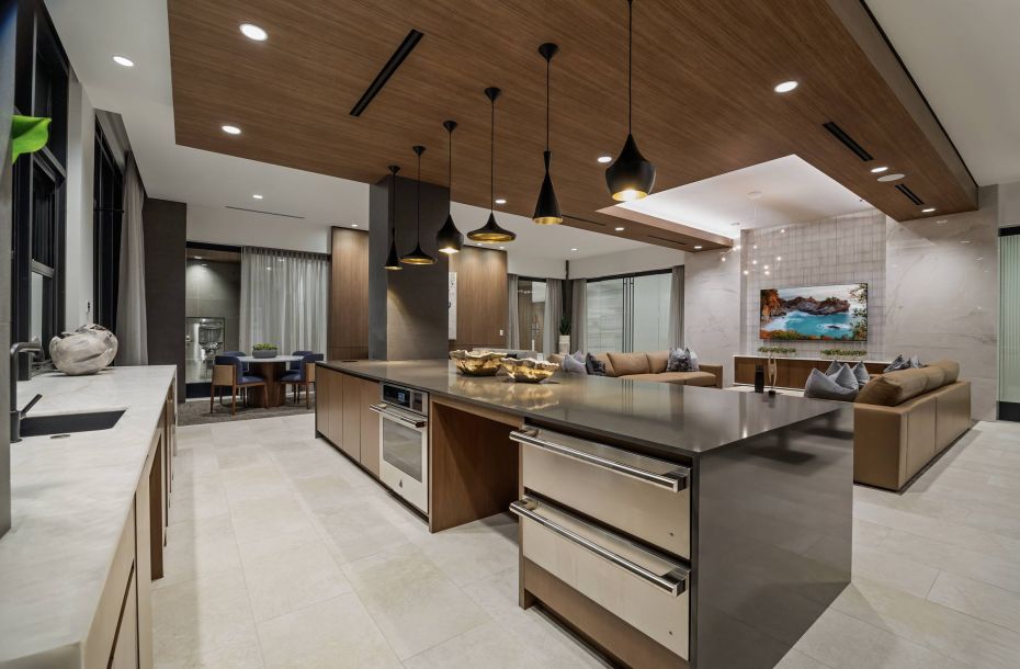 Hanover Company, Hanover Laguna Niguel Modern kitchen and living area with sleek design, featuring wood accents, pendant lights, and a large island.