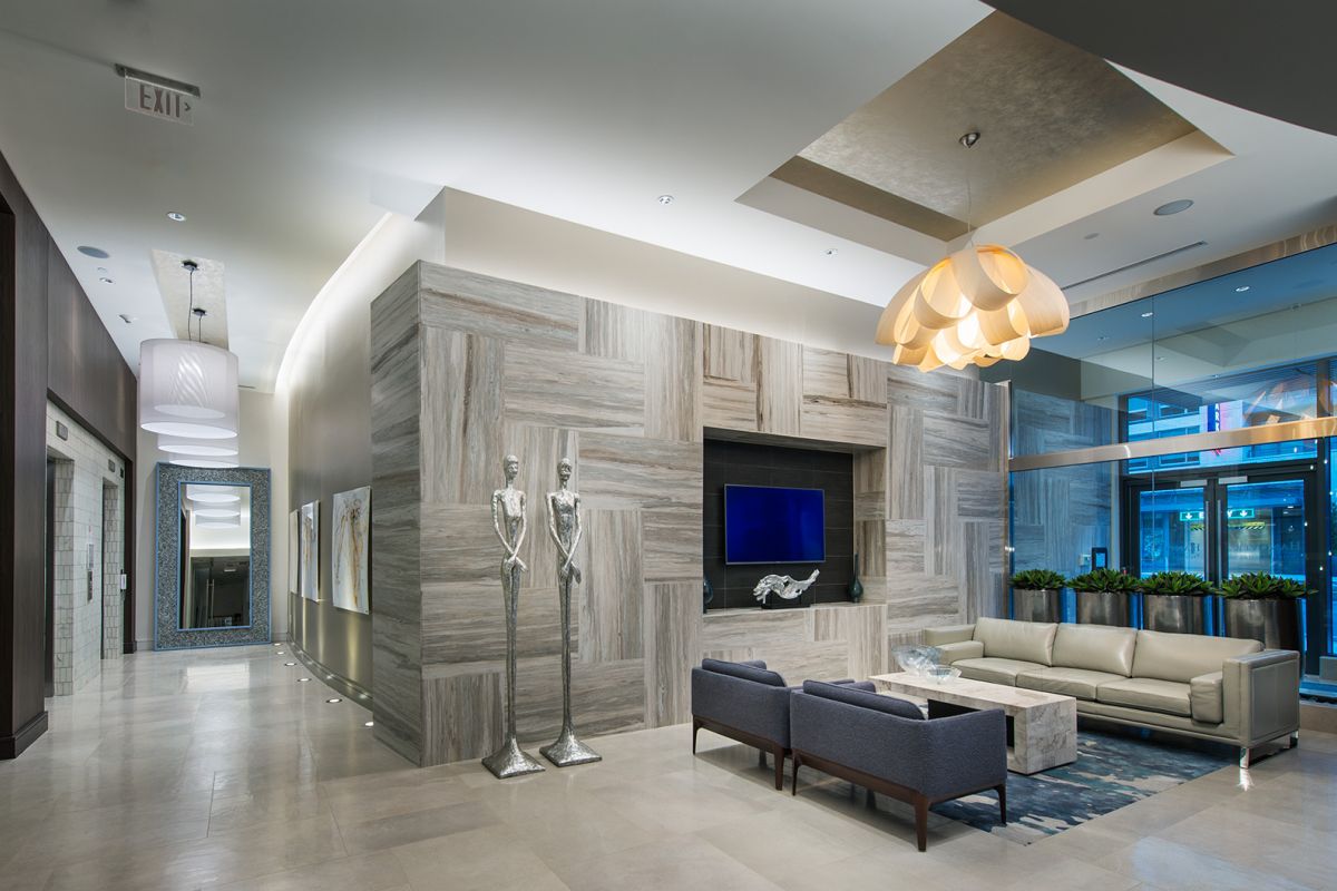 Modern lobby with stylish seating, large wall art, sculpture, and contemporary lighting fixtures.