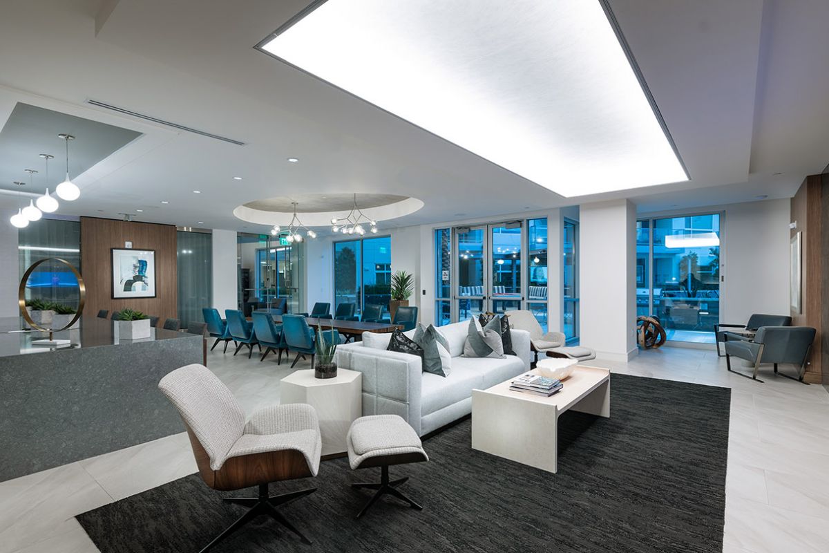 Modern lounge with stylish seating, large windows, and contemporary decor—experience luxury apartments at Hanover Diridon.