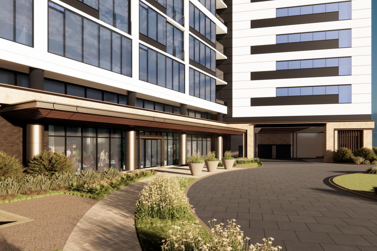 Modern building exterior with large windows, landscaped path, and potted plants under a blue sky.