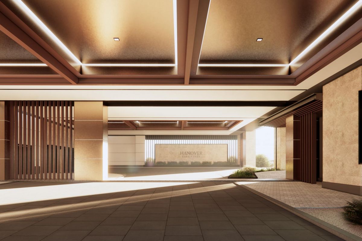 Modern, minimalist building entrance with geometric design, stone walls, and ceiling lights.