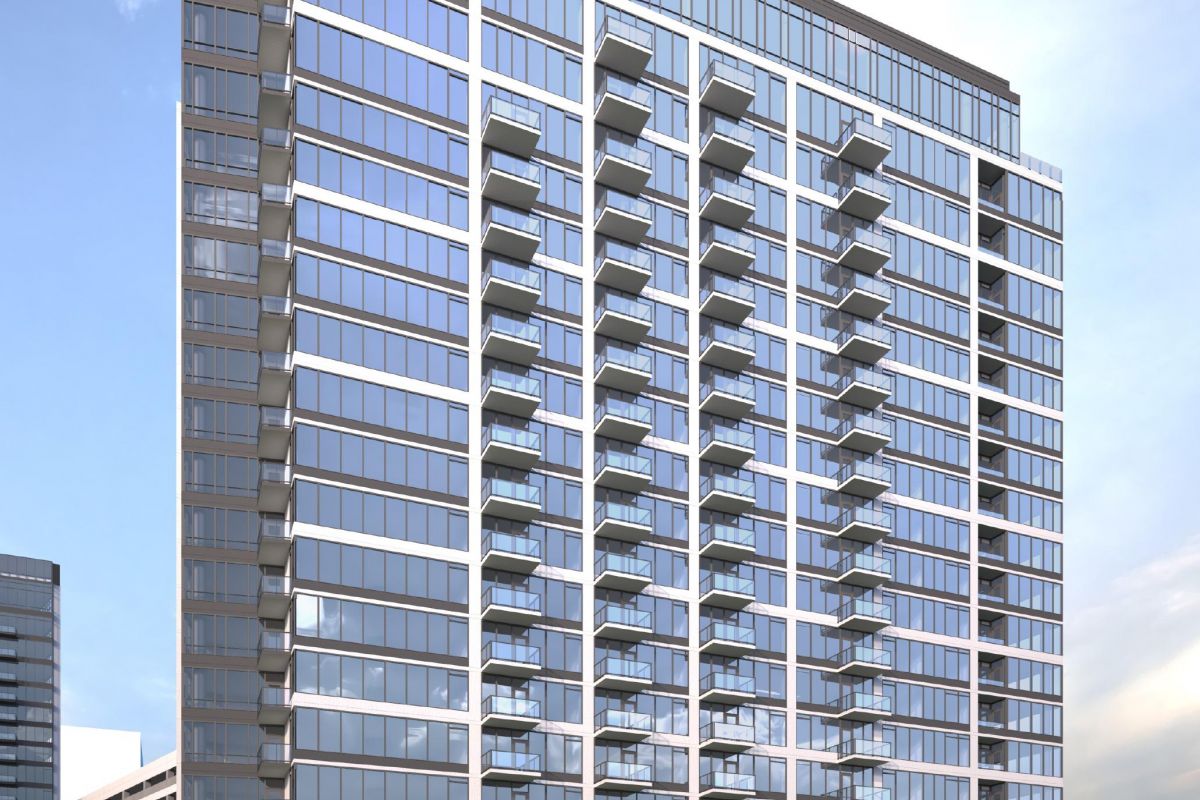 Modern high-rise building with glass facade and multiple balconies against a clear blue sky.