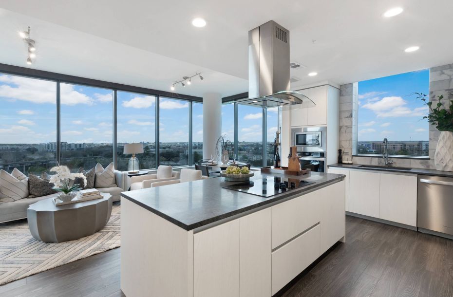Hanover Company, Hanover Autry Park Modern open-plan kitchen and living area with large windows, white cabinets, and a central island.